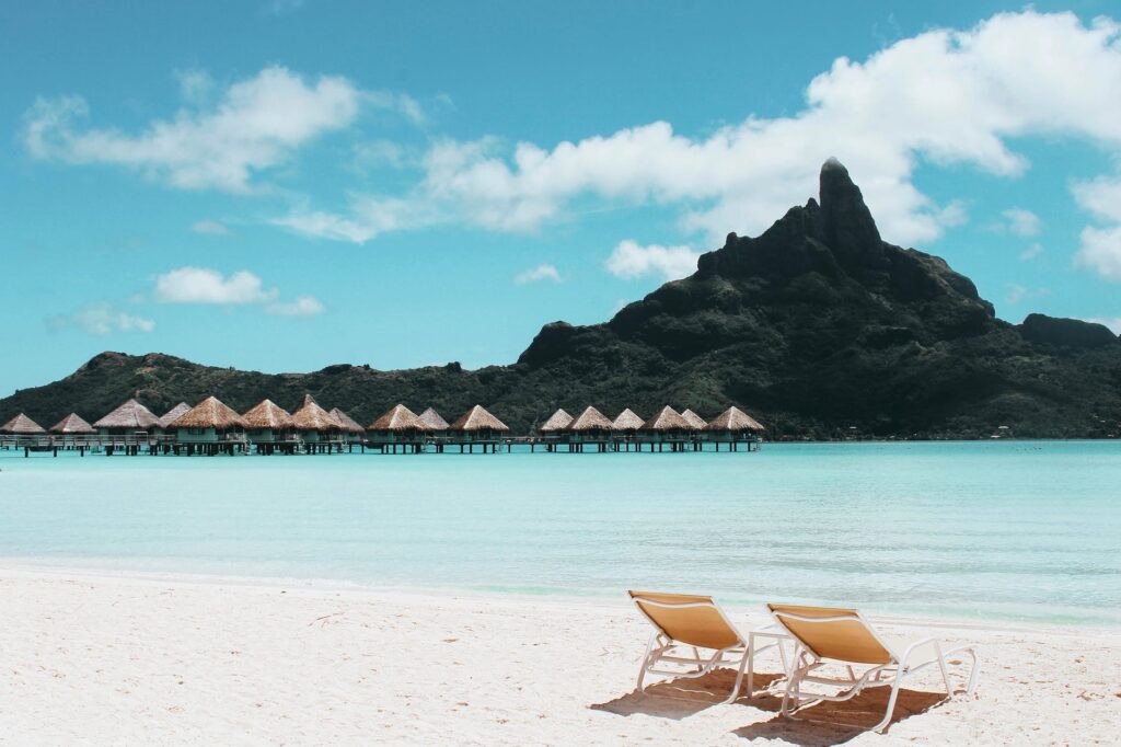 an island with cottages and beach chairs