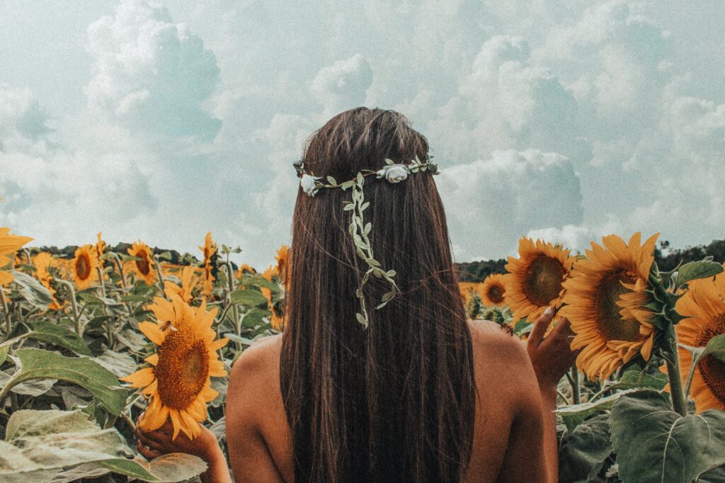 woman standing on sunflower field