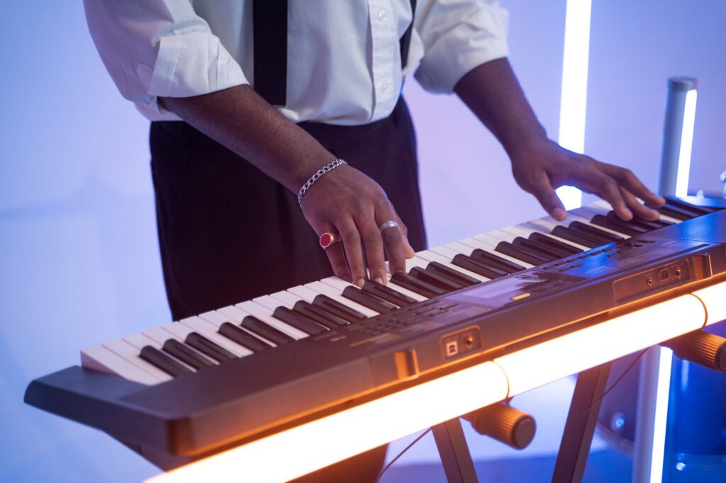 man in white dress shirt playing piano