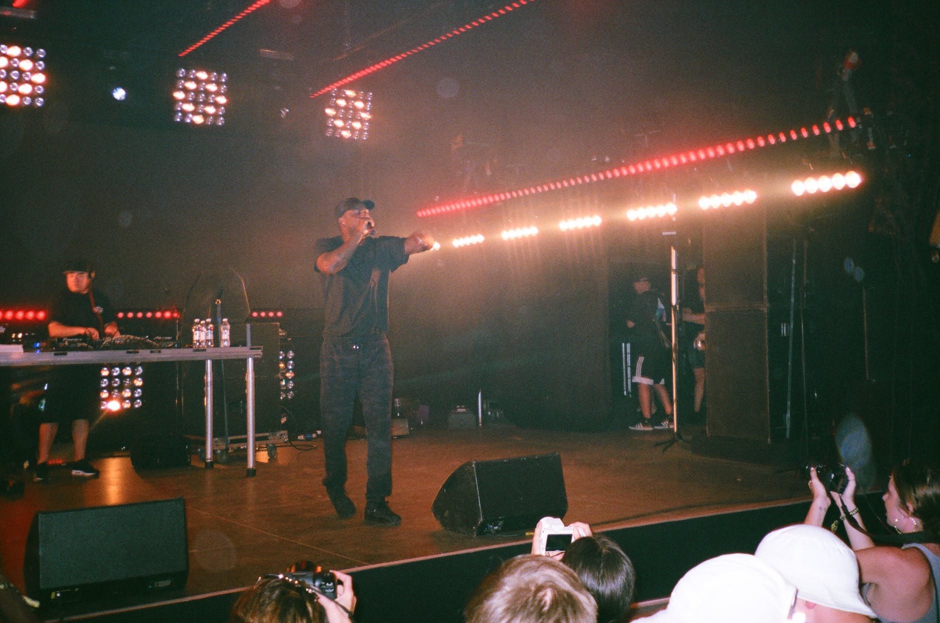 man standing on stage facing people