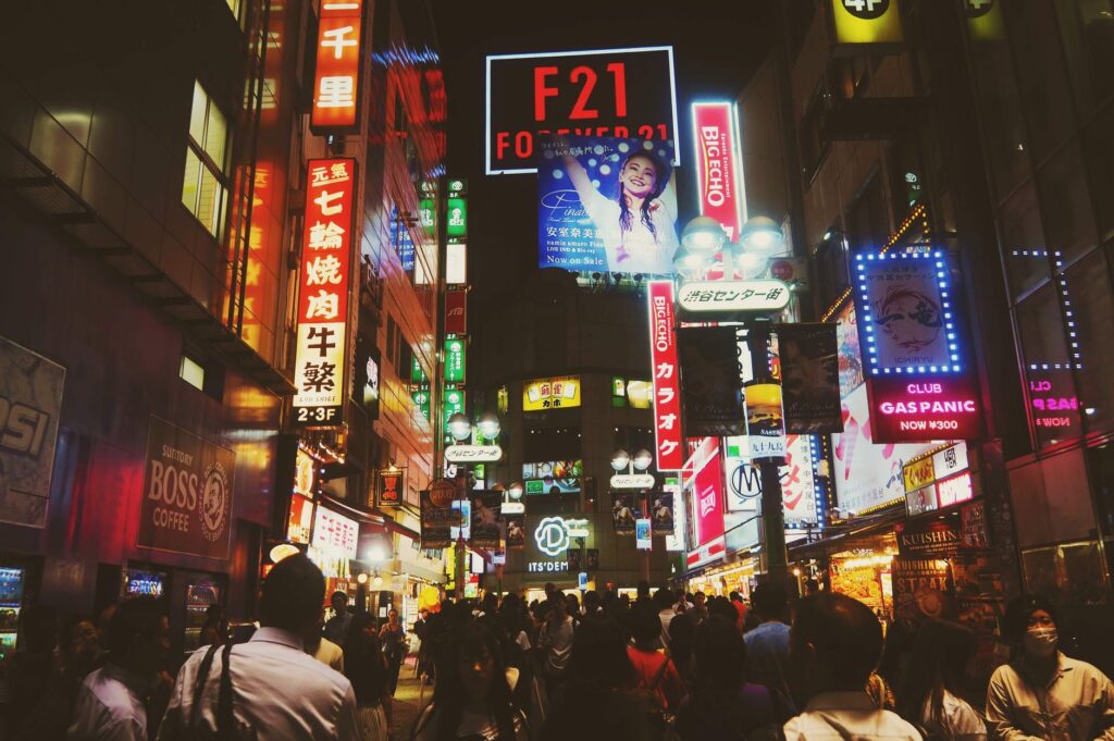 crowd of people under neon signs