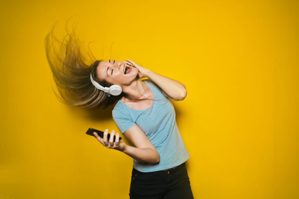 photography of woman listening to music