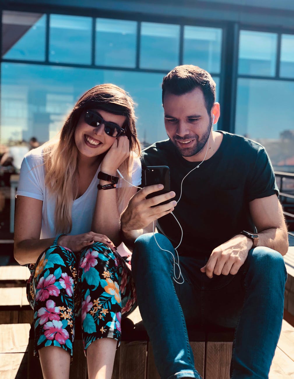 man and woman using an earphones