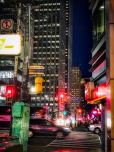 vehicles on street near tall buildings