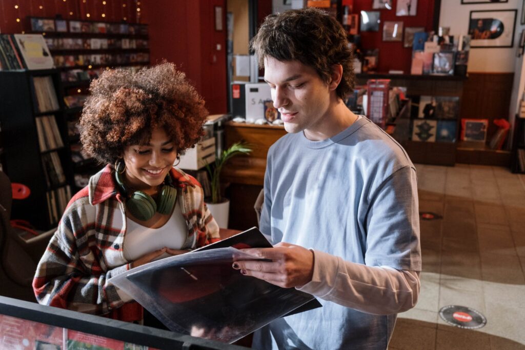 woman and man looking at a vinyl record