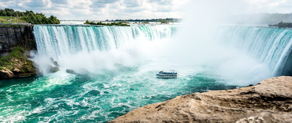 boat beside waterfalls